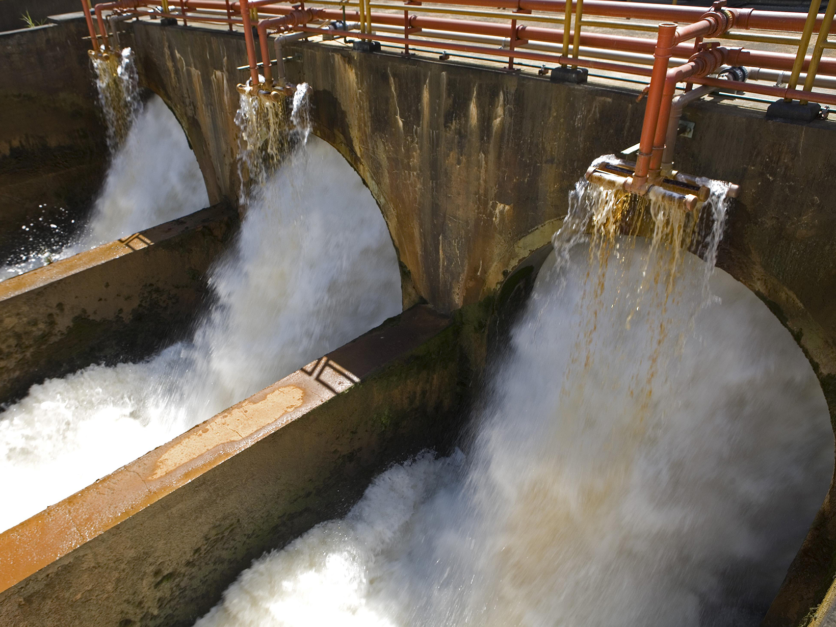 Water rushing through the gates of a dam.